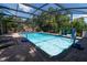 Relaxing enclosed in-ground pool with brick pavers and lounge chairs for ultimate outdoor comfort at 237 Manatee Rd, Winter Haven, FL 33884
