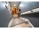 Staircase leading to the lower level with gray walls and gray weathered floors at 237 Manatee Rd, Winter Haven, FL 33884