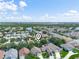 Aerial view of a community with lush landscaping and a lake at 2538 Crown Ridge Cir, Kissimmee, FL 34744