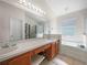 Bright bathroom with double vanity, soaking tub, and separate shower at 2538 Crown Ridge Cir, Kissimmee, FL 34744