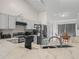 Well-lit kitchen with stainless steel appliances, light countertops, and an adjacent dining area at 2538 Crown Ridge Cir, Kissimmee, FL 34744