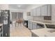 Bright kitchen featuring white cabinets, stainless steel appliances, and breakfast table at 2538 Crown Ridge Cir, Kissimmee, FL 34744