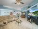 Bright living room with tile flooring, sectional sofa, ceiling fan and large TV at 2538 Crown Ridge Cir, Kissimmee, FL 34744