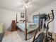 Spacious primary bedroom with a four-poster bed and tile flooring at 2538 Crown Ridge Cir, Kissimmee, FL 34744
