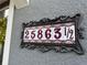 Beautiful address number tiled in decorative frame attached to home's exterior at 25863 Crossings Bluff Ln, Sorrento, FL 32776