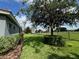 Spacious backyard with well-manicured lawn, landscaping, and an iron fence at 25863 Crossings Bluff Ln, Sorrento, FL 32776
