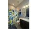 Charming bathroom featuring a blue whale-themed shower curtain and granite countertop vanity at 25863 Crossings Bluff Ln, Sorrento, FL 32776