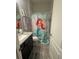 bathroom with a Little Mermaid themed shower curtain and granite vanity at 25863 Crossings Bluff Ln, Sorrento, FL 32776