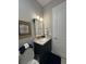 Stylish half bathroom featuring marble countertops and elegant wall decor at 25863 Crossings Bluff Ln, Sorrento, FL 32776