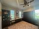 Bedroom with a ceiling fan, built-in shelving, desk, wood floors and an area rug at 25863 Crossings Bluff Ln, Sorrento, FL 32776
