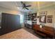 Bedroom with a ceiling fan, built-in shelving, desk, wood floors and a rug at 25863 Crossings Bluff Ln, Sorrento, FL 32776