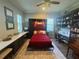 Charming bedroom with Murphy bed, ceiling fan and bonus desk with shelves at 25863 Crossings Bluff Ln, Sorrento, FL 32776
