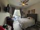 Well lit bedroom featuring an exterior door to a pool, hardwood floors and large bed at 25863 Crossings Bluff Ln, Sorrento, FL 32776