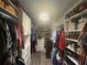 Walk-in closet offers extensive storage solutions with shelving and racks for optimal organization at 25863 Crossings Bluff Ln, Sorrento, FL 32776