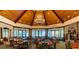 The clubhouse features a spacious dining area with a stone fireplace and floor-to-ceiling windows at 25863 Crossings Bluff Ln, Sorrento, FL 32776