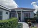 Charming home exterior with a well-manicured lawn and inviting entryway at 25863 Crossings Bluff Ln, Sorrento, FL 32776