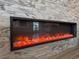 Modern fireplace with a decorative rock bed and long sleek black frame at 25863 Crossings Bluff Ln, Sorrento, FL 32776