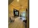 Inviting foyer boasting a high ceiling, decorative light fixture, neutral tones and tile flooring at 25863 Crossings Bluff Ln, Sorrento, FL 32776