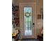 Elegant front door featuring decorative glass and adjacent Gathering photos at 25863 Crossings Bluff Ln, Sorrento, FL 32776