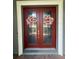 Front door with double doors and wreaths with glass panes surrounded by a light frame at 25863 Crossings Bluff Ln, Sorrento, FL 32776