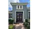 An inviting entryway is highlighted by a double door entry, beautiful landscaping, and textured exterior walls at 25863 Crossings Bluff Ln, Sorrento, FL 32776