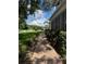 Beautiful brick pathway leading to the front door, surrounded by lush landscaping and a well-maintained lawn at 25863 Crossings Bluff Ln, Sorrento, FL 32776