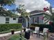 Charming home featuring a landscaped front yard with chairs and a brick walkway at 25863 Crossings Bluff Ln, Sorrento, FL 32776