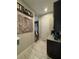 Hallway leading to dining with coffee bar featuring stone counter and a wine refrigerator at 25863 Crossings Bluff Ln, Sorrento, FL 32776