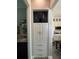 Hallway with built-in storage and view into bathroom and kitchen at 25863 Crossings Bluff Ln, Sorrento, FL 32776