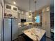 Bright kitchen featuring granite countertops, a central island, and modern appliances at 25863 Crossings Bluff Ln, Sorrento, FL 32776