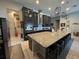 Spacious kitchen island with barstool seating and stainless appliances at 25863 Crossings Bluff Ln, Sorrento, FL 32776