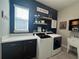 Functional laundry room with modern washer and dryer, ample counter space, and stylish decor at 25863 Crossings Bluff Ln, Sorrento, FL 32776
