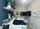Efficient laundry area with modern appliances, stylish decor, and convenient shelving at 25863 Crossings Bluff Ln, Sorrento, FL 32776