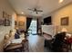 Cozy living room with a modern fireplace and view of the pool area at 25863 Crossings Bluff Ln, Sorrento, FL 32776