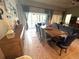 Living and dining area with backyard access, comfortable seating, and natural light at 25863 Crossings Bluff Ln, Sorrento, FL 32776