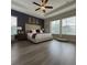 Inviting main bedroom featuring a decorative ceiling fan, large windows, and wood-look floors at 25863 Crossings Bluff Ln, Sorrento, FL 32776