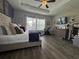 Spacious main bedroom with hardwood floors, a ceiling fan, and multiple windows for natural light at 25863 Crossings Bluff Ln, Sorrento, FL 32776