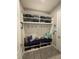 Well-organized mudroom with storage shelves, shoe racks, and a comfortable bench at 25863 Crossings Bluff Ln, Sorrento, FL 32776