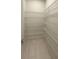 Walk-in pantry with tiled flooring and multiple rows of sturdy, coated-metal shelving at 25863 Crossings Bluff Ln, Sorrento, FL 32776