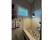 Pet shower with river rock floor and textured white tile at 25863 Crossings Bluff Ln, Sorrento, FL 32776