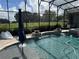 Screened-in pool area featuring a slide and manicured landscaping at 25863 Crossings Bluff Ln, Sorrento, FL 32776