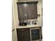 Modern wet bar area with beverage fridge, coffee maker, and storage at 25863 Crossings Bluff Ln, Sorrento, FL 32776