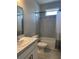 Well-maintained bathroom features tiled shower and tub, with a clean toilet and bright mirror at 2609 Village Lakes Blvd, Lakeland, FL 33805