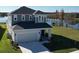Charming two-story home featuring a two-car garage and beautiful landscaping backing onto a serene lake view at 2609 Village Lakes Blvd, Lakeland, FL 33805