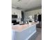Modern kitchen featuring sleek white cabinets, stainless steel appliances, and a quartz countertop island at 2609 Village Lakes Blvd, Lakeland, FL 33805