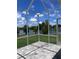 Relaxing screened patio with a paver floor offering serene lake views and refreshing breezes at 2609 Village Lakes Blvd, Lakeland, FL 33805