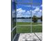 Serene screened patio with a paver floor providing stunning views of the adjacent lake at 2609 Village Lakes Blvd, Lakeland, FL 33805