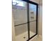 Modern shower with a sliding glass door, tiled walls, and a built-in niche at 2609 Village Lakes Blvd, Lakeland, FL 33805