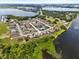 Expansive aerial view of a community nestled by lakes with verdant landscapes and clear blue skies at 2740 Rochelle Dr, Winter Haven, FL 33881