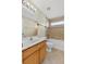 Well-lit bathroom with a single sink vanity, ceramic tile flooring and a combined shower and bathtub at 2740 Rochelle Dr, Winter Haven, FL 33881